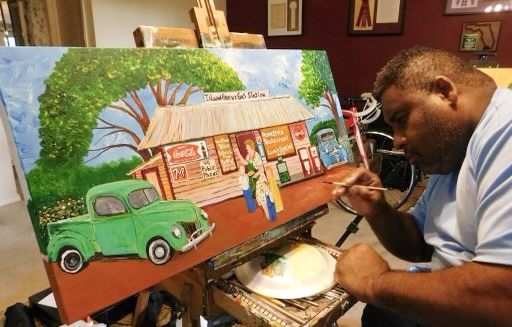 Mr. Ernest M. Lee paints "Island Grove Gas Station" at his home studio in 2012.